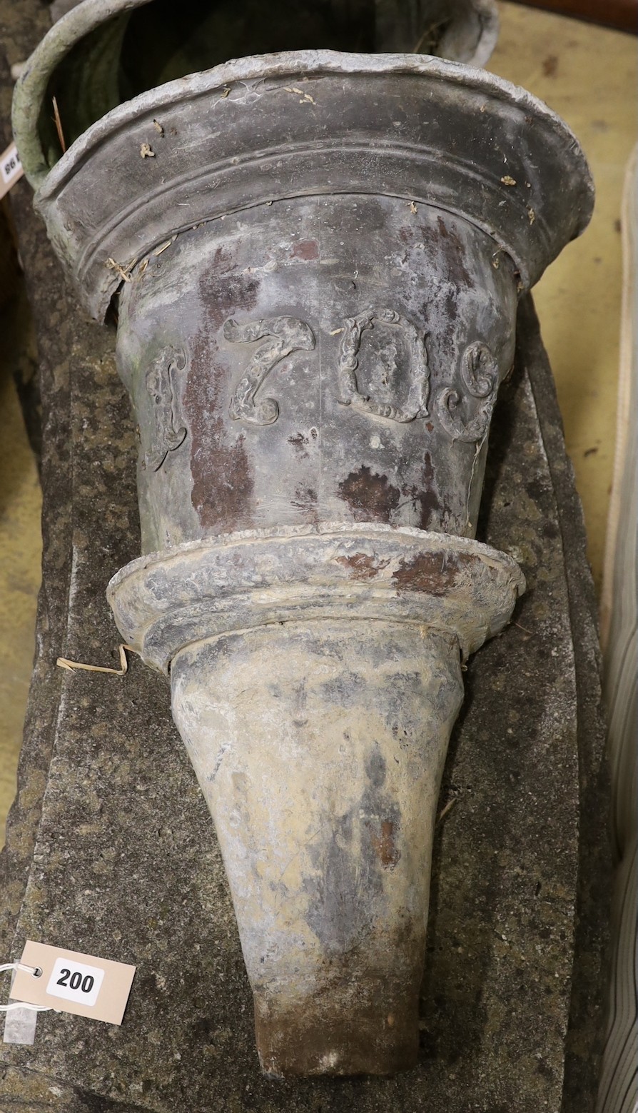 Two 18th century lead rain hoppers, one dated 1709, the other 1764 and initialled I M, larger height 59cm